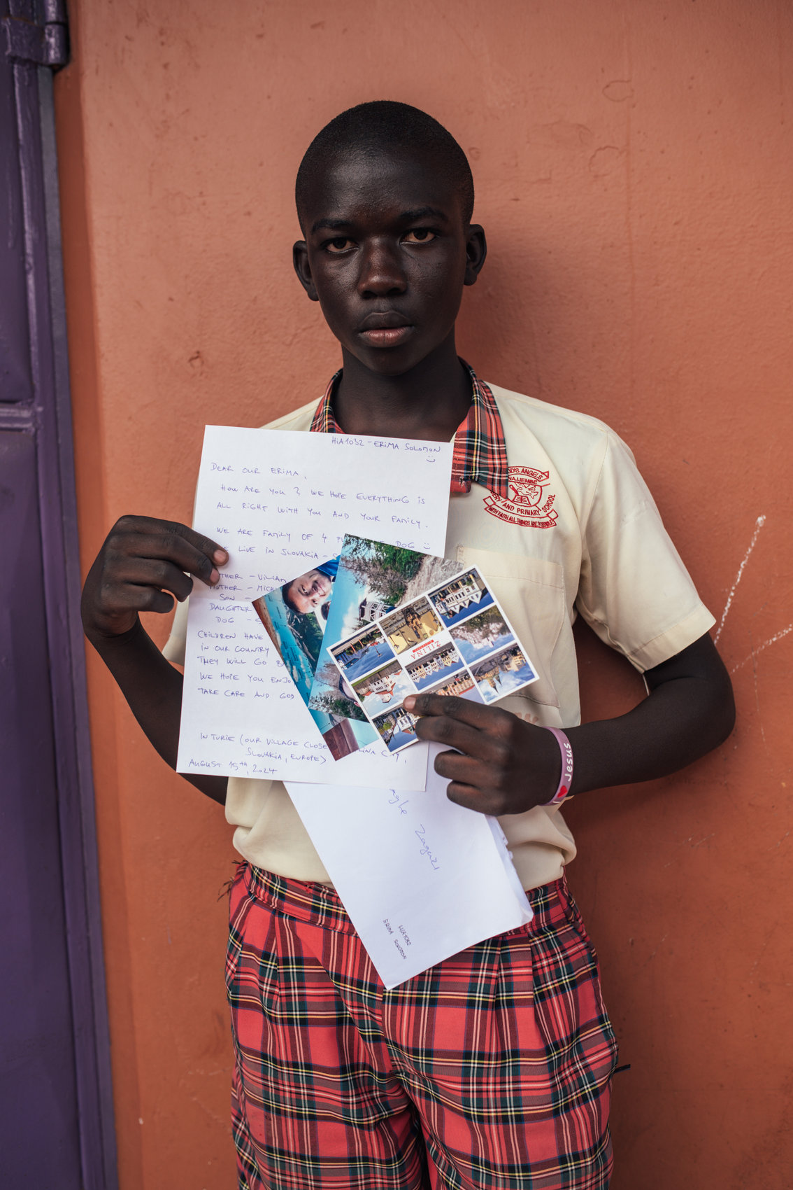 Boy holding letters and photos